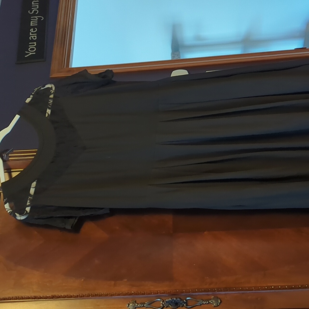 Black dress with lace detail and pockets.
